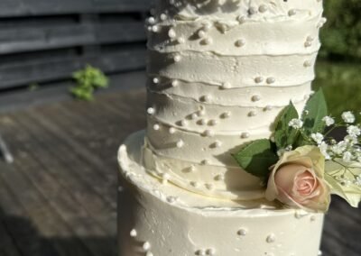 3-lag bryllupskake med roser og perleperler